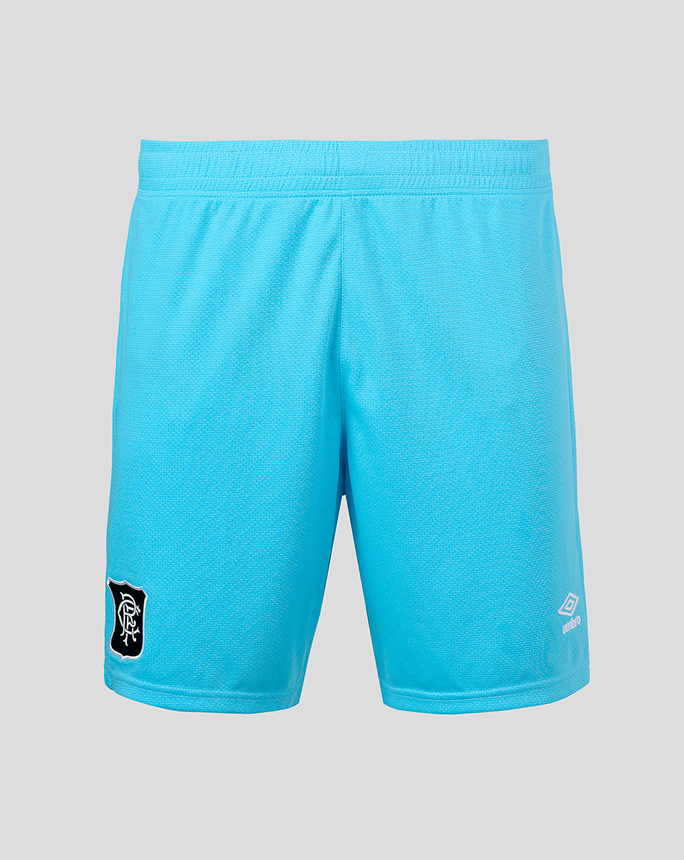 Bright turquoise blue athletic shorts with a textured mesh fabric, featuring a black and white crest patch on the left leg and a white logo on the right leg, displayed against a solid gray background.