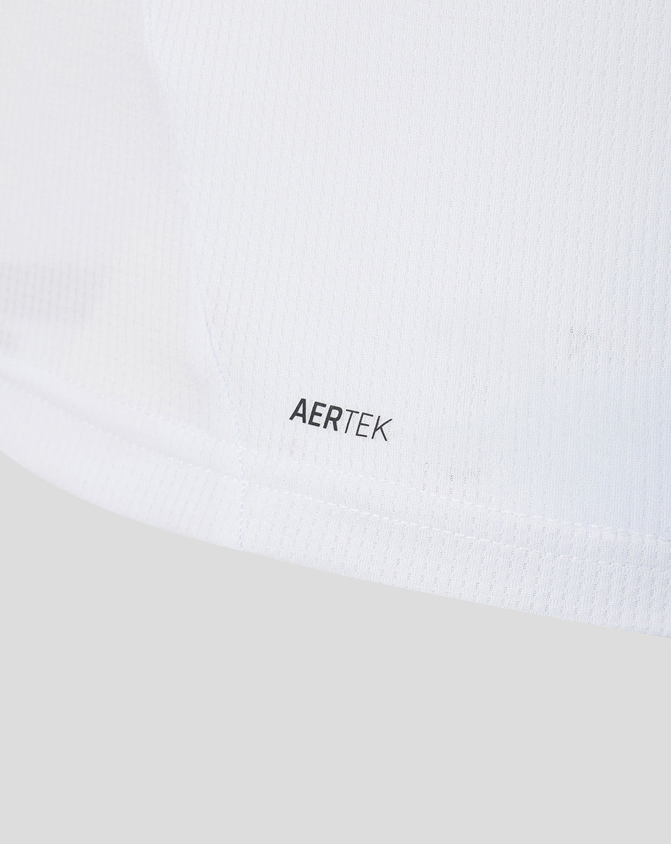 Close up of white knit fabric with AERTEK branding near the hem of the away shirt