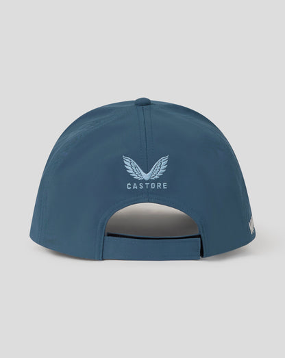 Blue cap with 'Castore' logo on a light gray background
