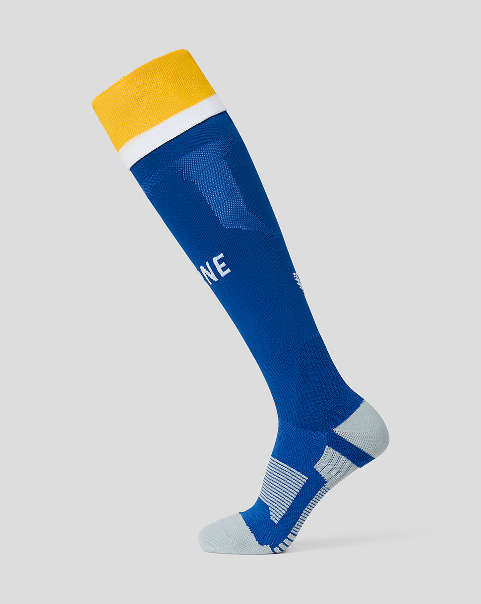 Blue knee-high sock with yellow top on a light gray background