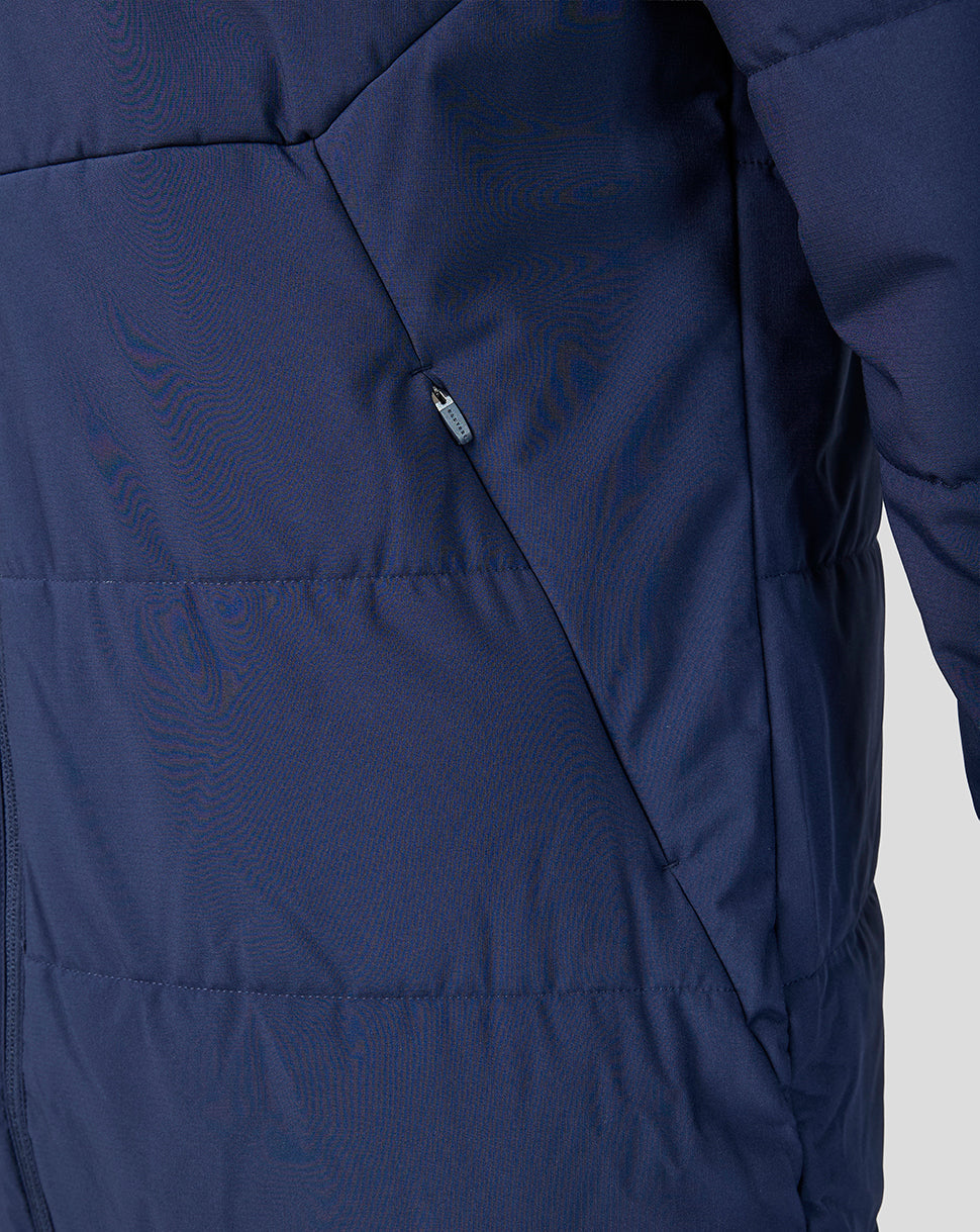 Close-up of a navy blue jacket with a zipper on a light gray background