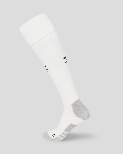 White knee-high sock with a small logo on a light gray background