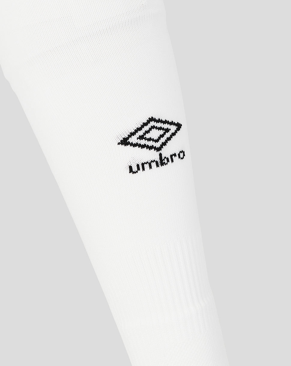 Close-up of a white shirt with a black Umbro logo on a light gray background