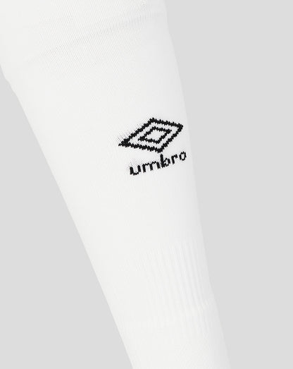 Close-up of a white shirt with a black Umbro logo on a light gray background