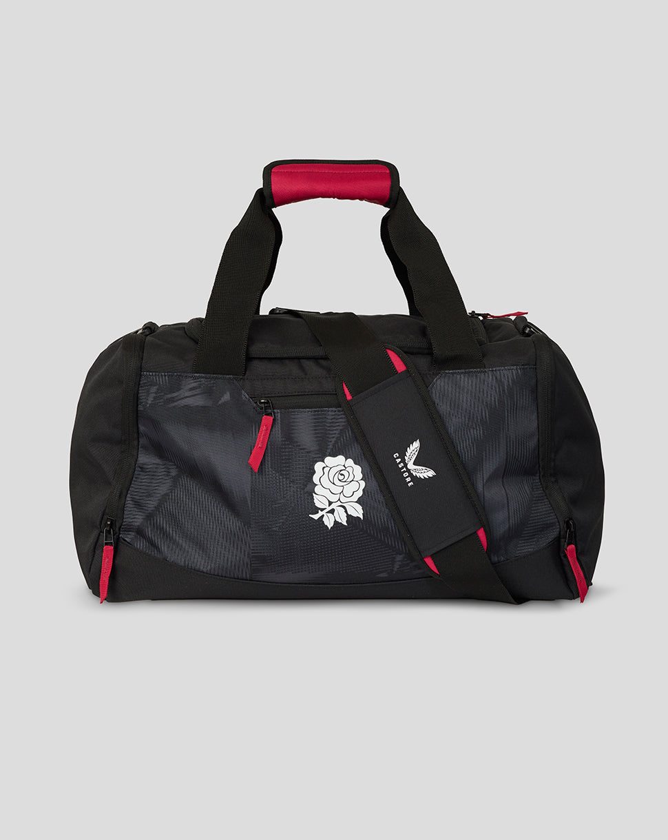Black duffel bag with red accents and a logo on a gray background