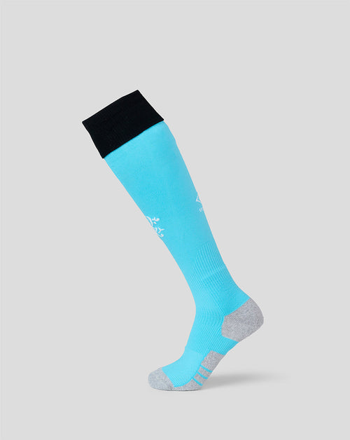 A single knee-high athletic sock in bright turquoise blue with a black cuff, gray toe and heel, and white printed branding, shown on a light gray background.