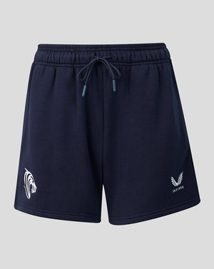 Front view of navy travel shorts with drawstring waist and logos on each leg.