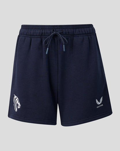 Front view of navy travel shorts with drawstring waist and logos on each leg.