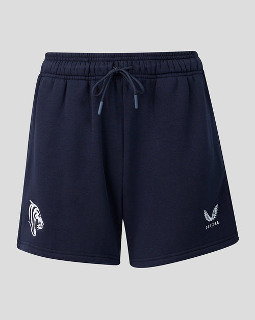 Front view of navy travel shorts with drawstring waist and logos on each leg.