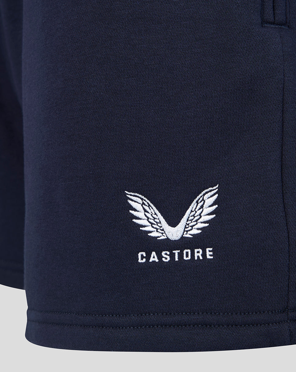 Close up of navy shorts featuring white Castore logo with wing embroidery.