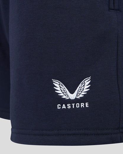 Close up of navy shorts featuring white Castore logo with wing embroidery.
