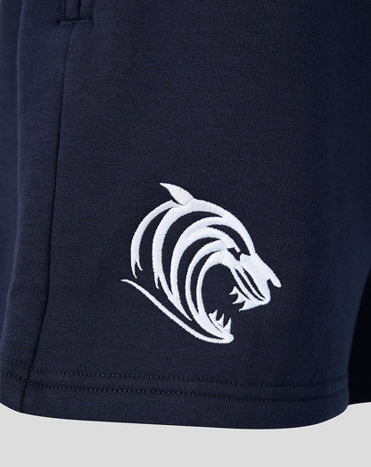 Close up of navy Leicester Tigers travel shorts showing white tiger head logo embroidered on the leg.