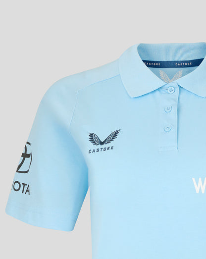 Light blue polo shirt with visible branding on a light gray background