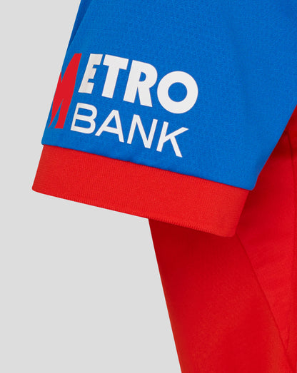 Red jacket with Metro Bank logo on a light gray background