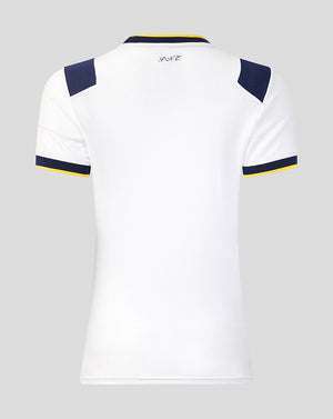 White sports jersey with navy and yellow accents on a gray background