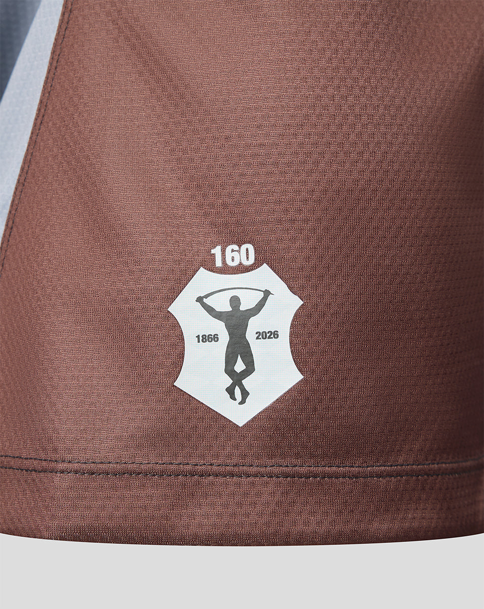 Close-up of a brown fabric with a logo featuring a silhouette and text on a light gray background