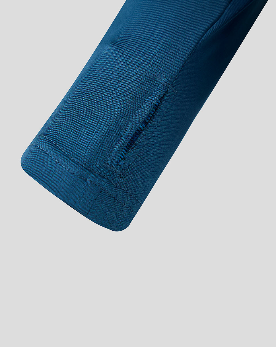 Close up of blue Leicester Tigers training top sleeve cuff showing durable knit fabric and clean stitching.