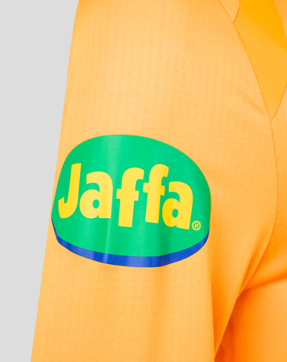 Close-up of a bright orange athletic jersey sleeve featuring a large green oval Jaffa logo with yellow lettering and a blue outline.