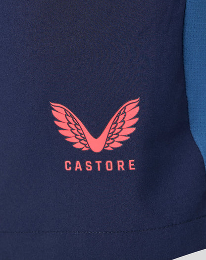 Close-up of a navy blue jacket with a red Castore logo on a white background