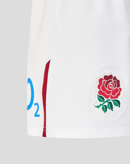 White sports kit with red rose emblem on a gray background