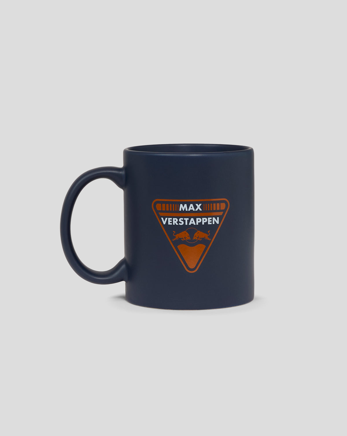 Dark blue mug featuring the orange Max Verstappen Red Bull Racing crest on the front with a handle on the left.