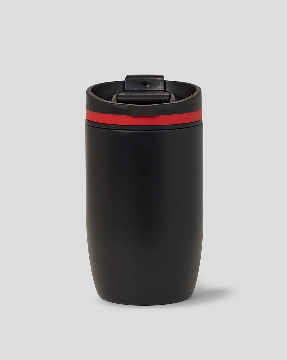 Black tumbler with a red band on a gray background