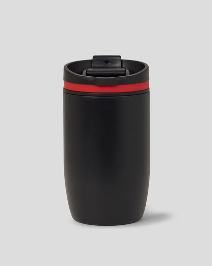 Black tumbler with a red band on a gray background