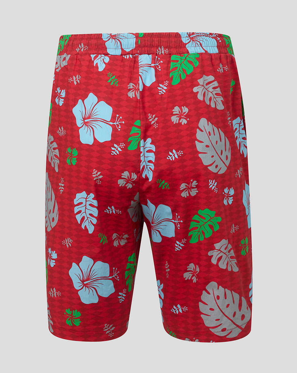 Red shorts with tropical floral pattern on a gray background