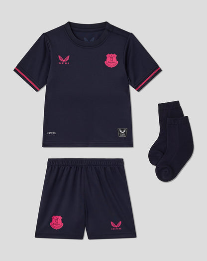 Navy sports outfit with pink accents on a gray background