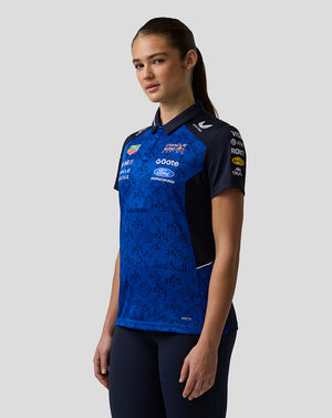 Person wearing a blue and black sports jersey with various sponsor logos on a white background