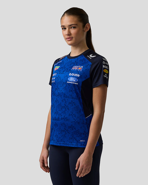 Person wearing a blue and black sports jersey with various sponsor logos on a white background