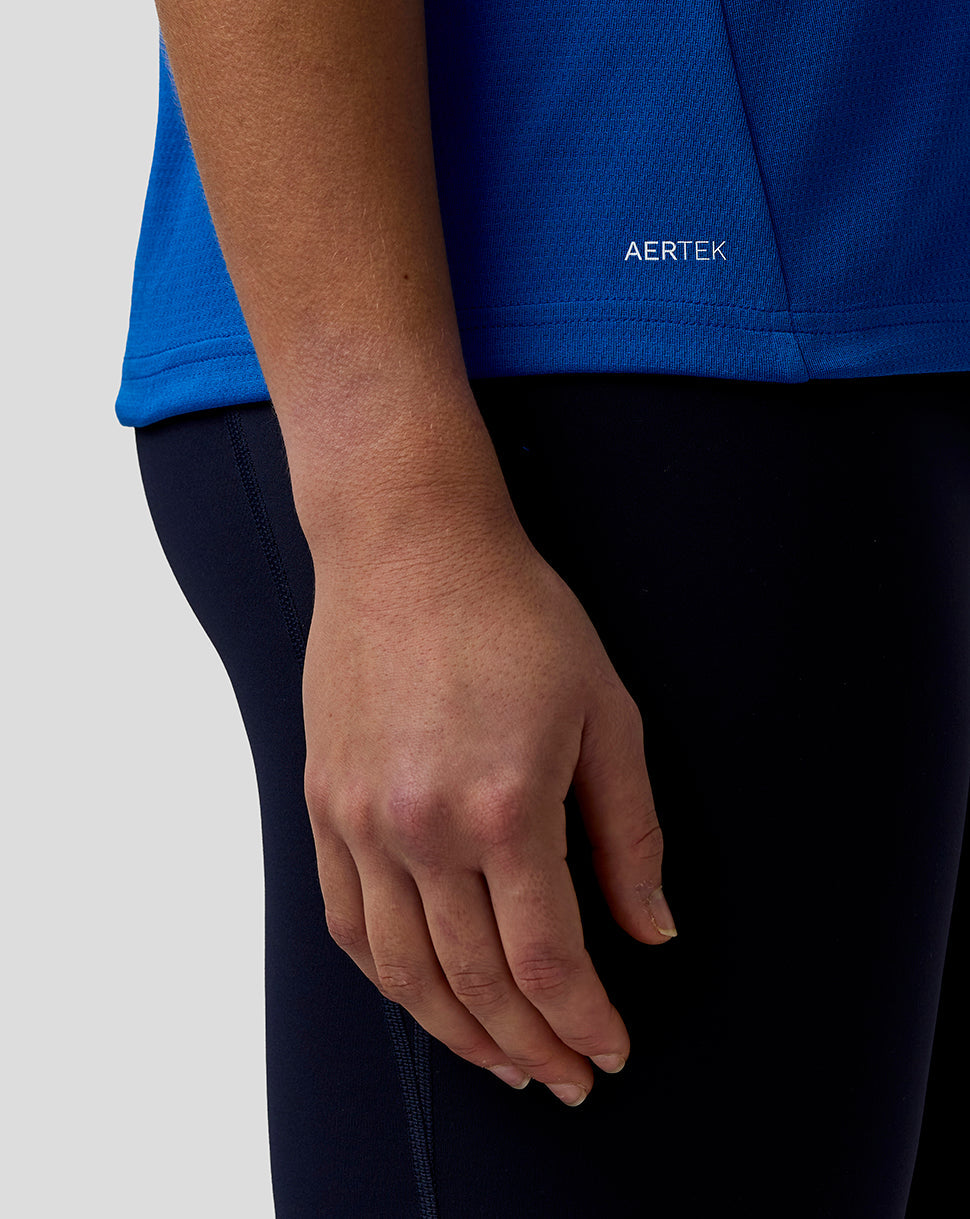 Person wearing a blue shirt with 'AERTEK' branding