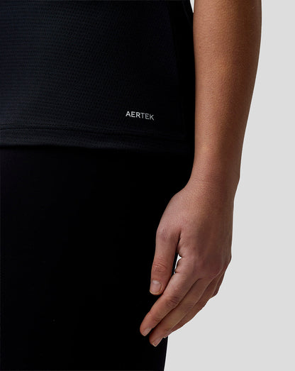 Person wearing a black AERTEK shirt with a close-up of the hand.