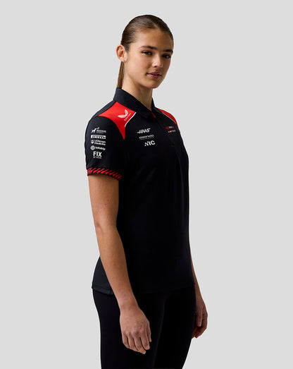 Person wearing a black racing suit with red and white accents on a gray background