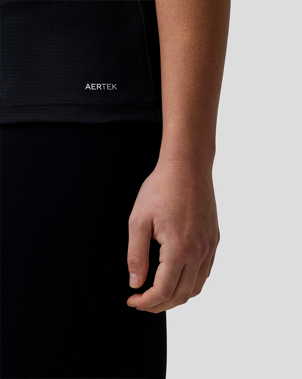 Person wearing a black shirt with 'AERTEK' logo