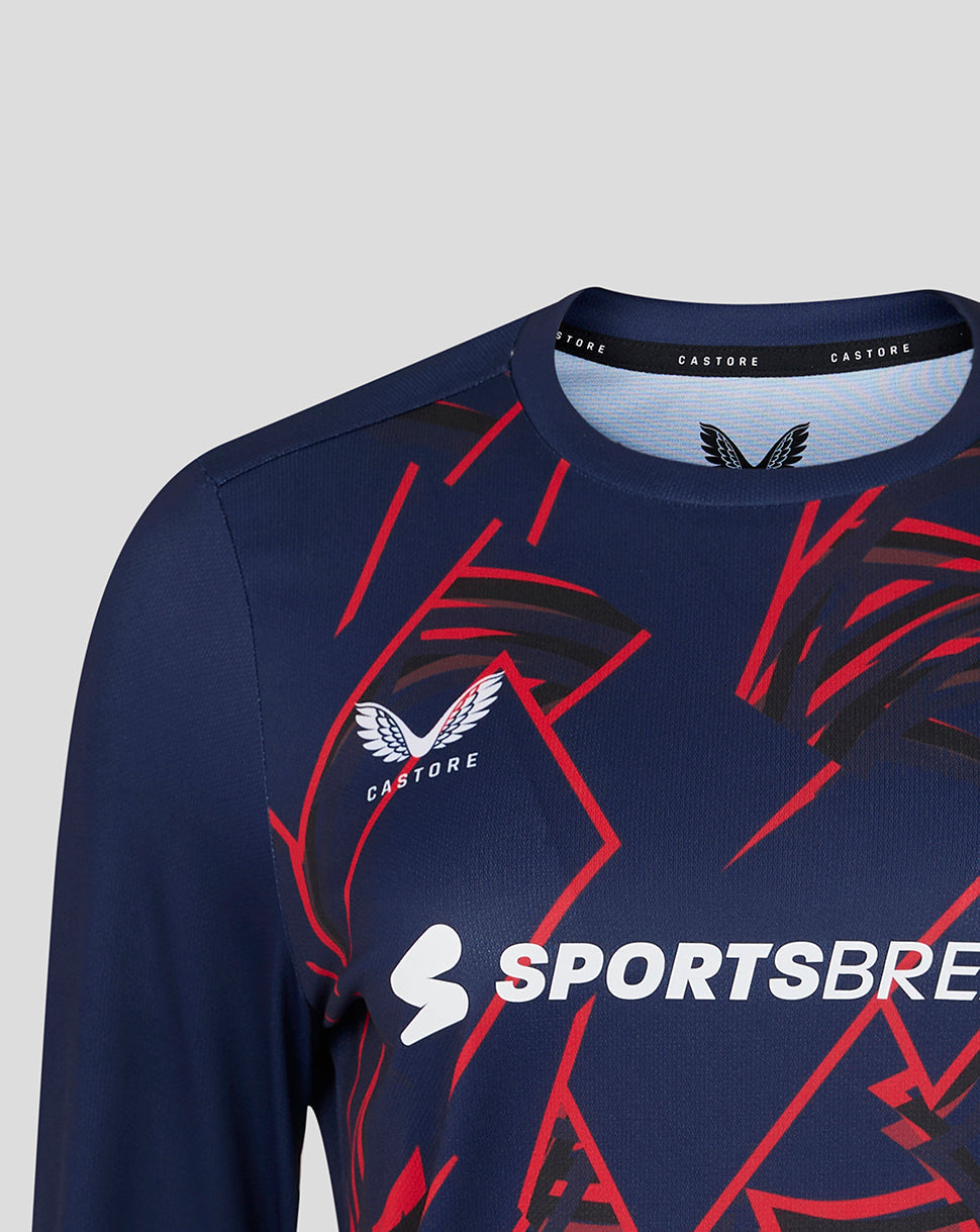 Navy sports jersey with red and white patterns and visible Castore and Sportsbre logos on a light gray background.