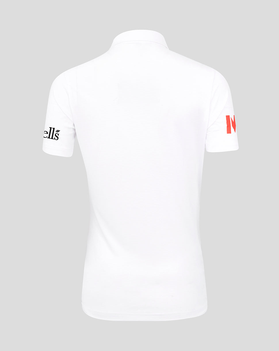 White polo shirt with branding on sleeves against a gray background