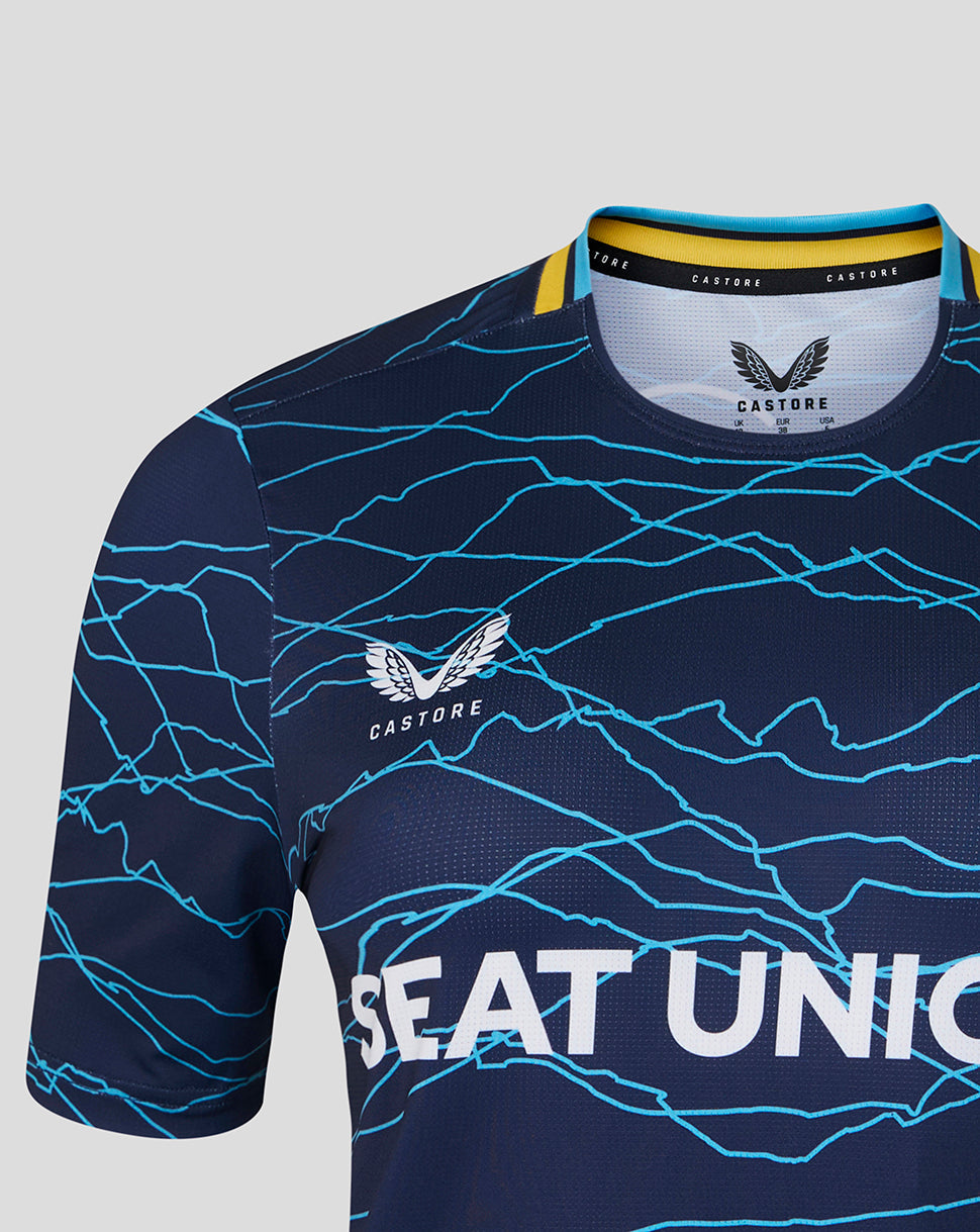 Navy sports jersey with blue patterns and 'Castore' branding on a light gray background