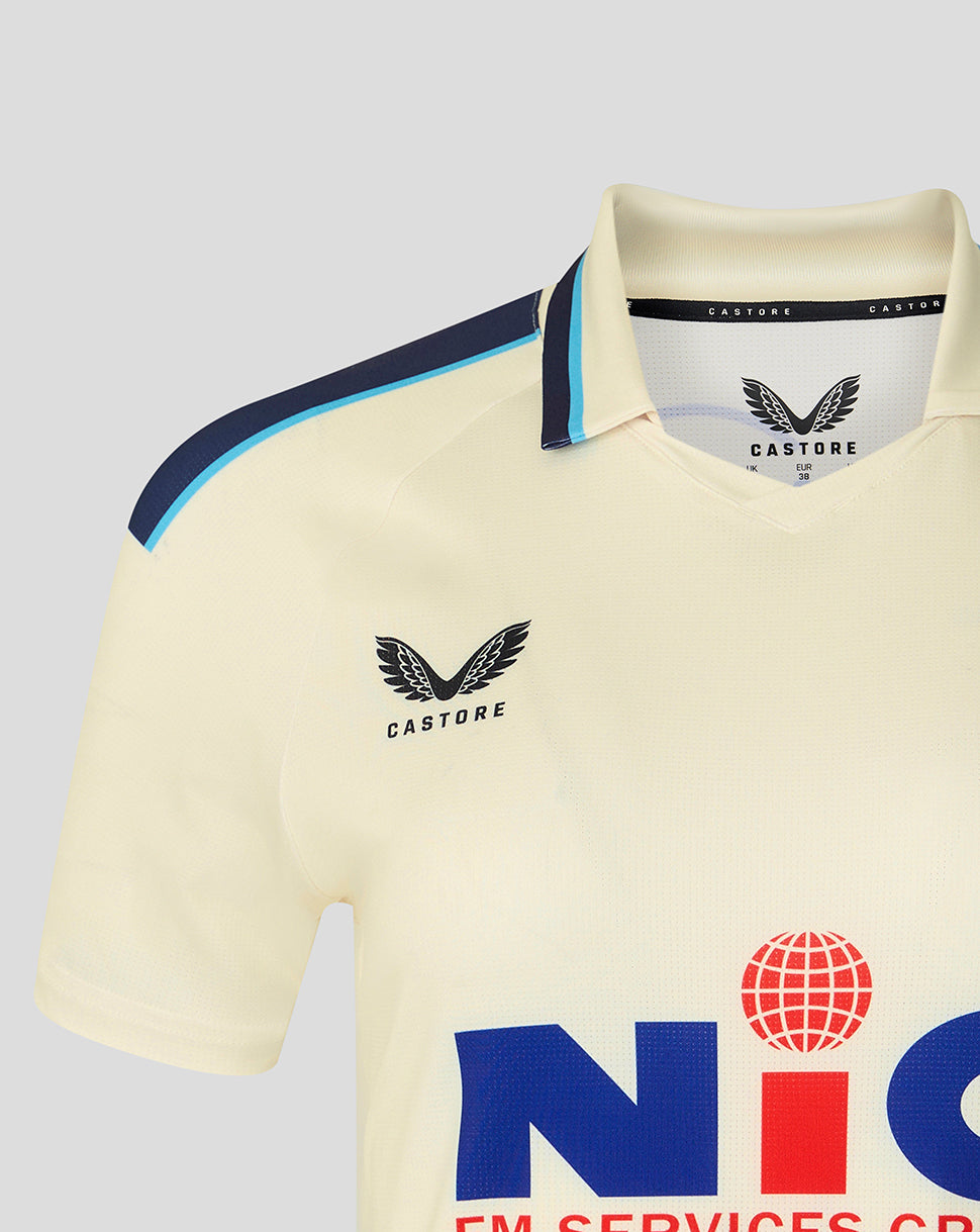 Beige polo shirt with visible branding on a light gray background