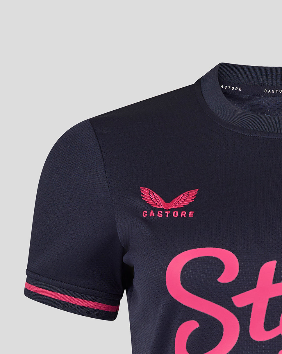 Navy football jersey with pink accents and 'Castore' branding on a light gray background