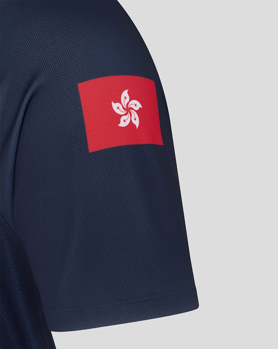 Navy blue shirt with a red and white emblem on the sleeve against a light gray background