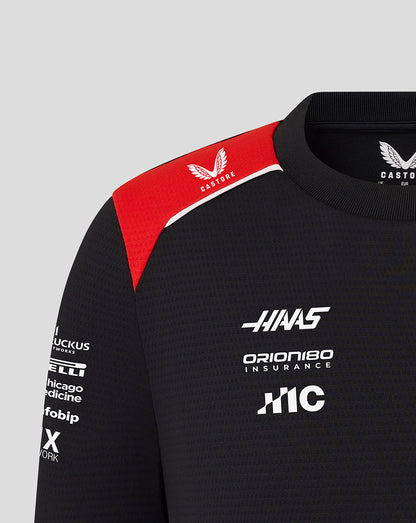 Black sweatshirt with red accents and various logos on a gray background
