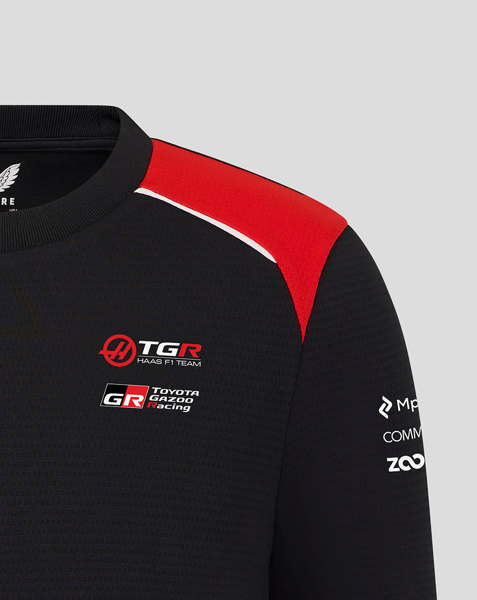Black and red sports jacket with logos on a gray background