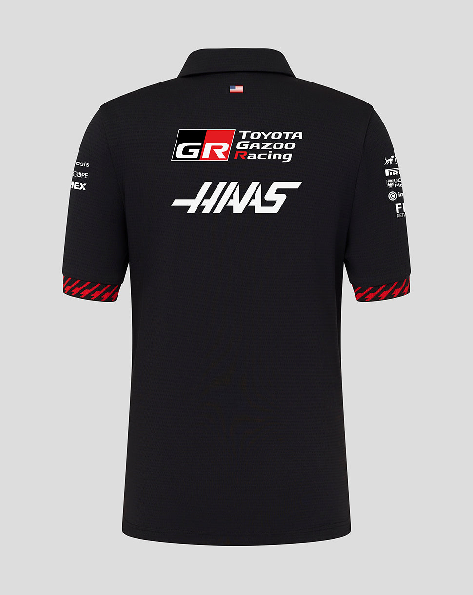Black polo shirt with Toyota Gazoo Racing and Haas logos on a gray background