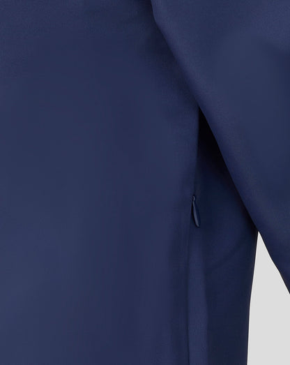 Close-up of a navy blue garment with a zipper on a light gray background