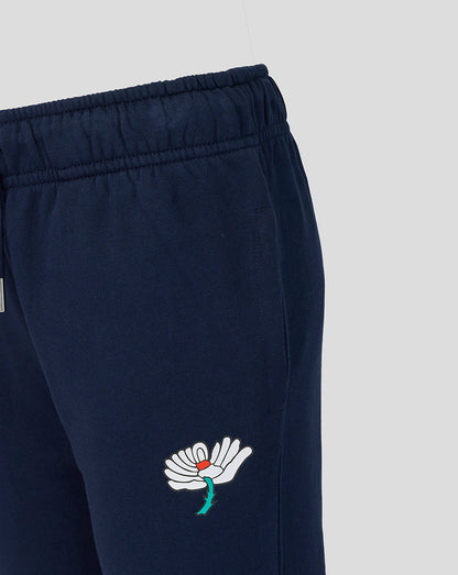 Navy blue pants with a white embroidered design on a light gray background