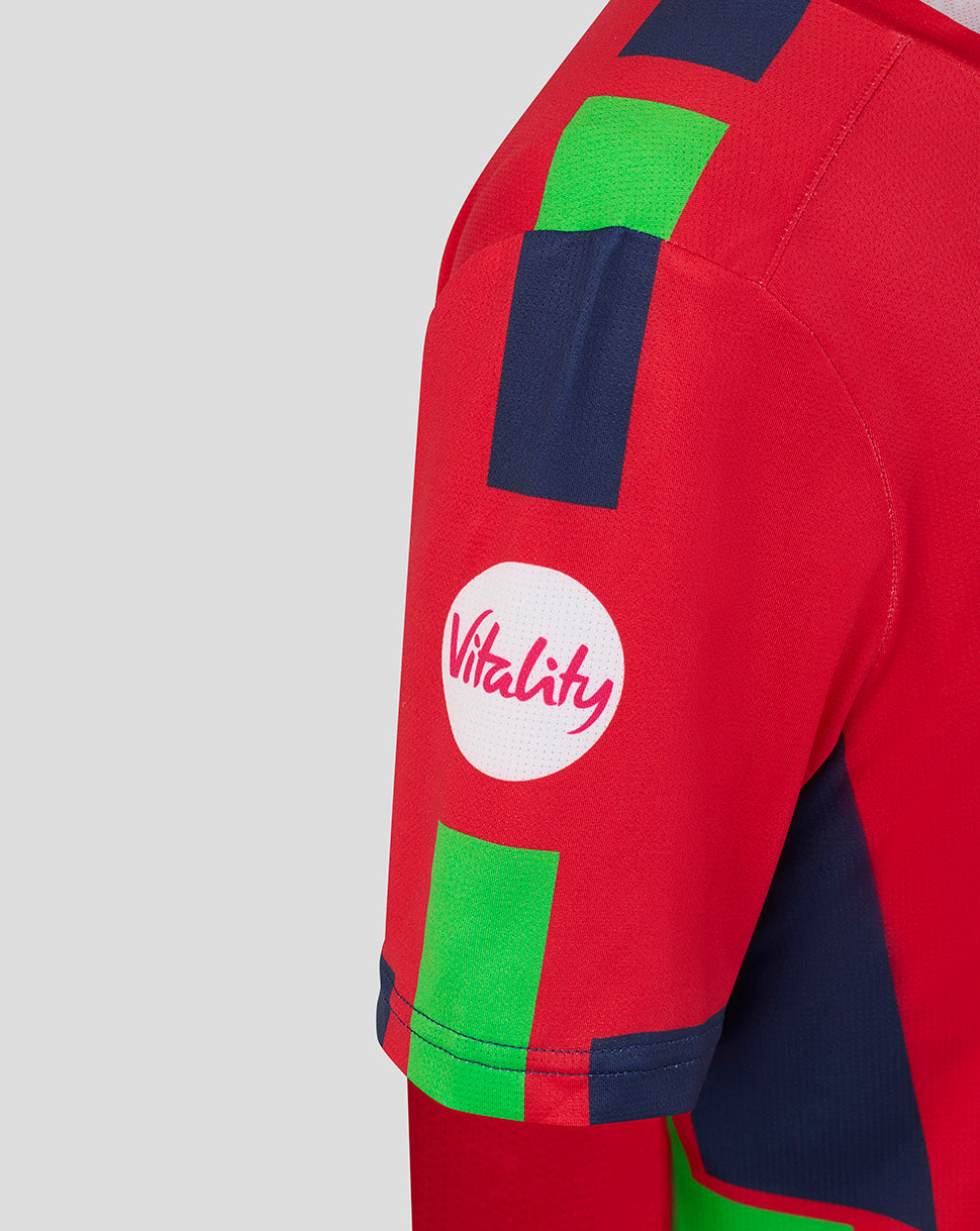 Red sports jersey with green and blue patches and a 'Vitality' logo on a gray background