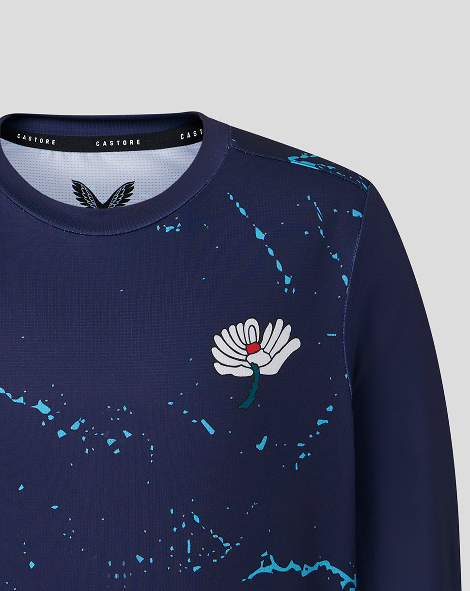 Navy blue sweatshirt with a white floral design on a light gray background