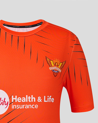Close up of neckline and Sunrisers Leeds crest on orange juniors training T shirt