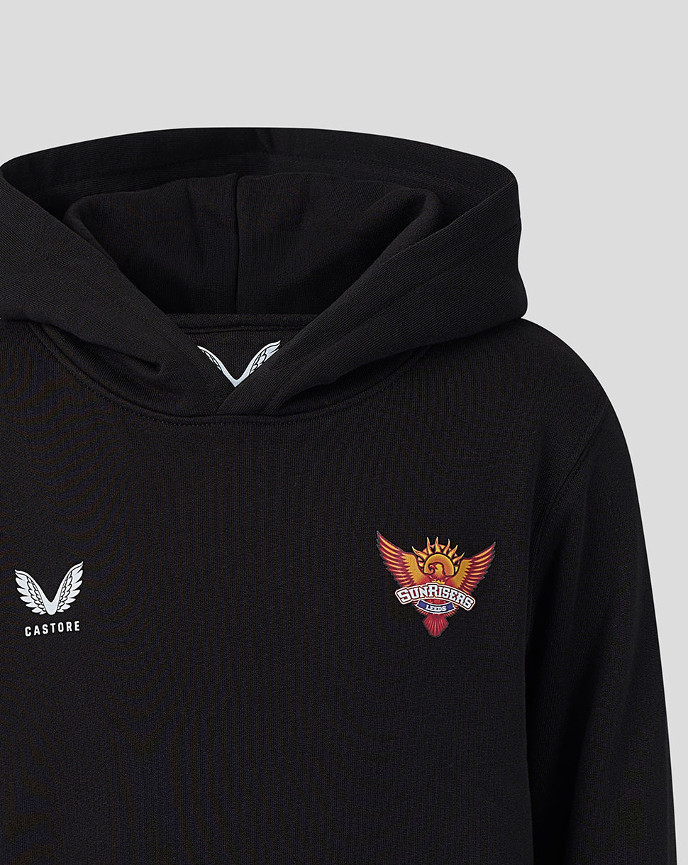 Close up of black juniors hoodie with Castore logo on the left chest and Sunrisers Leeds crest on the right under the hood